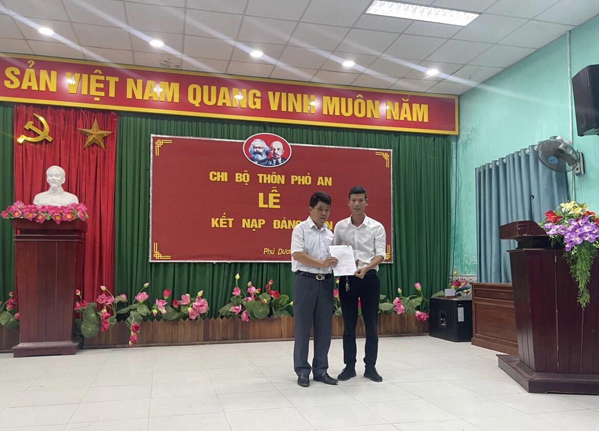 Đồng chí Đặng Phú Quý - Bí thư chi bộ thôn Phò An trao Quyết định kết nạp đảng viên cho các đồng chí Phan Thế Anh; Phan Trung Thức